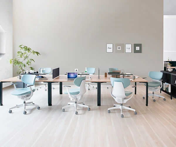 Modern office meeting room with ergonomic blue chairs and conference table